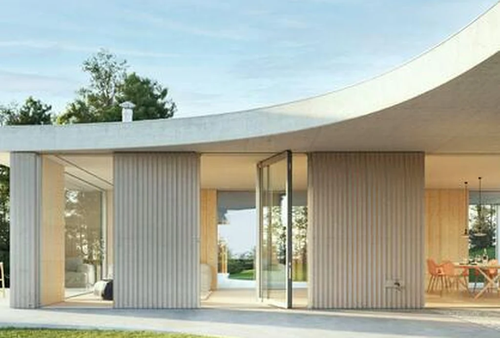 Curved-roof house with a Schüco AD AL 75 pivot door on the garden elevation