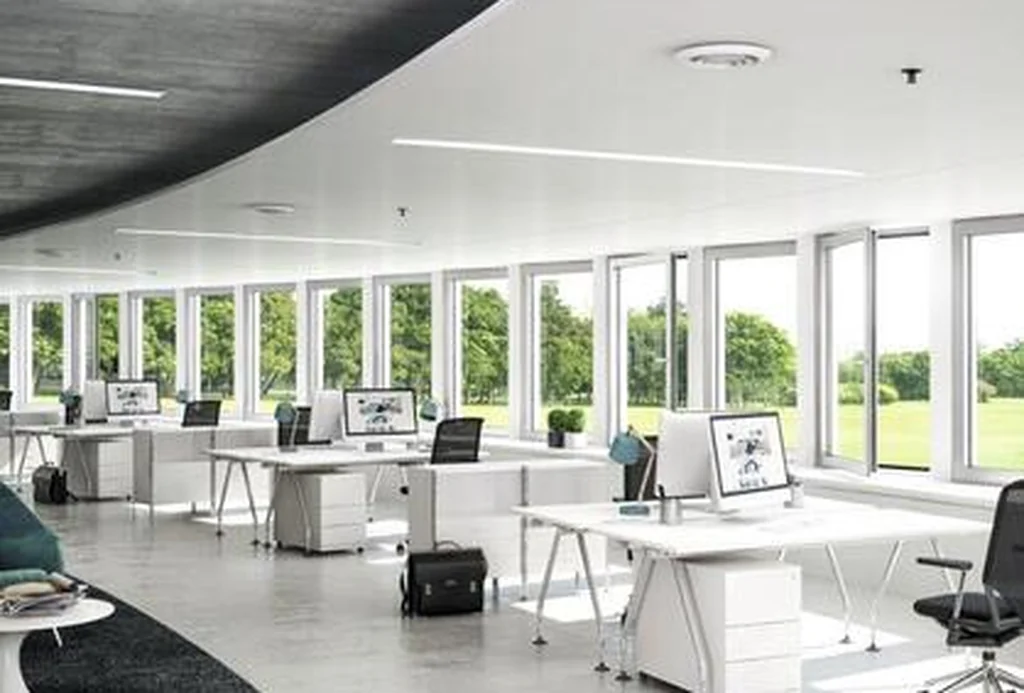 Open-plan office interior with a continuous ribbon of Schüco AWS 75.SI+ windows