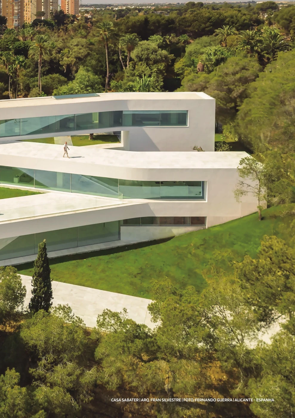 Casa Sabater seen from the garden, its long glazed façade built from Sosoares OS minimalist sliding units