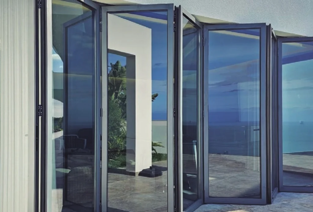 Bi-folding doors, installed detail — the Sosoares HT sash stack folded back against the reveal