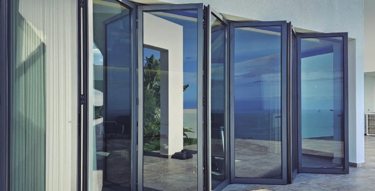 Bi-folding doors, installed detail — the HT sash stack folded back against the reveal